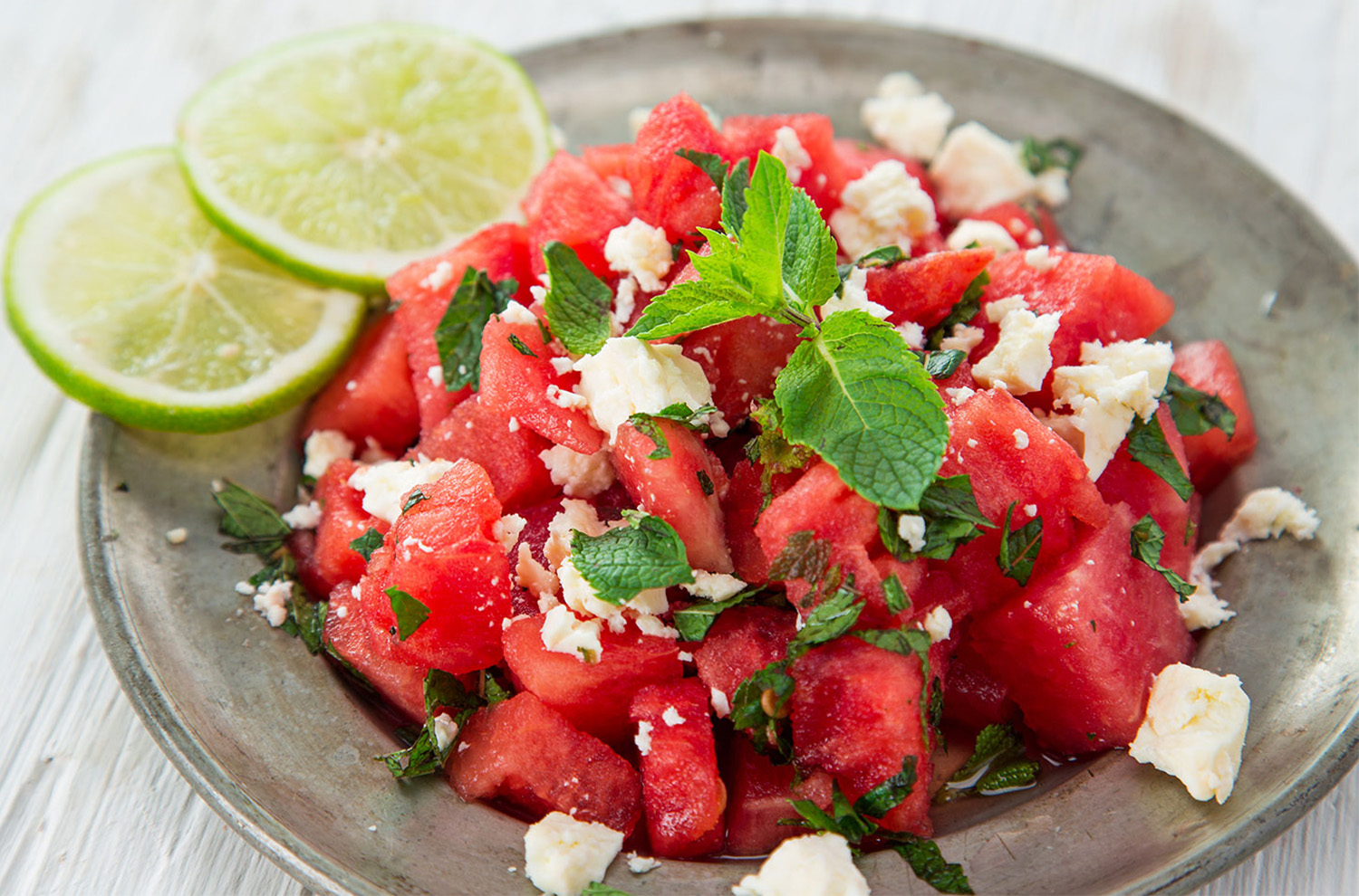 Bowl of watermelon salad with feta, mint, and lime