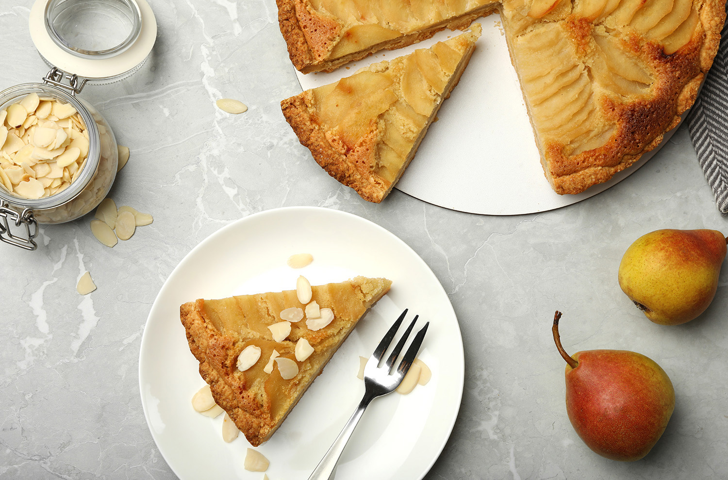 plate with a slice of pear almond tart