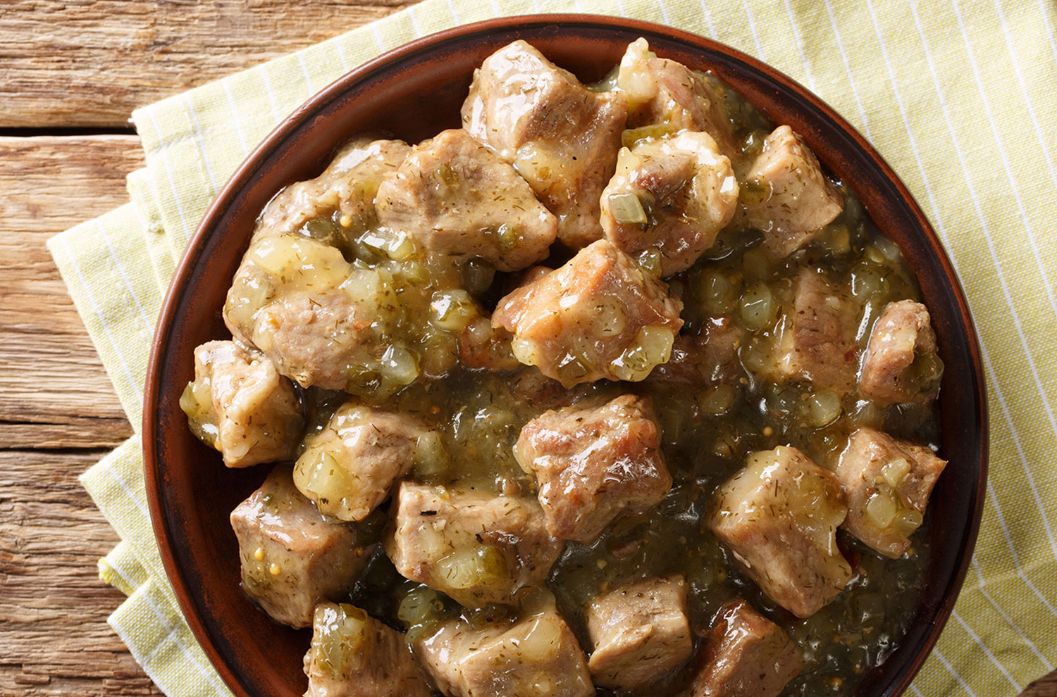 bowl of chili verde on wooden table top