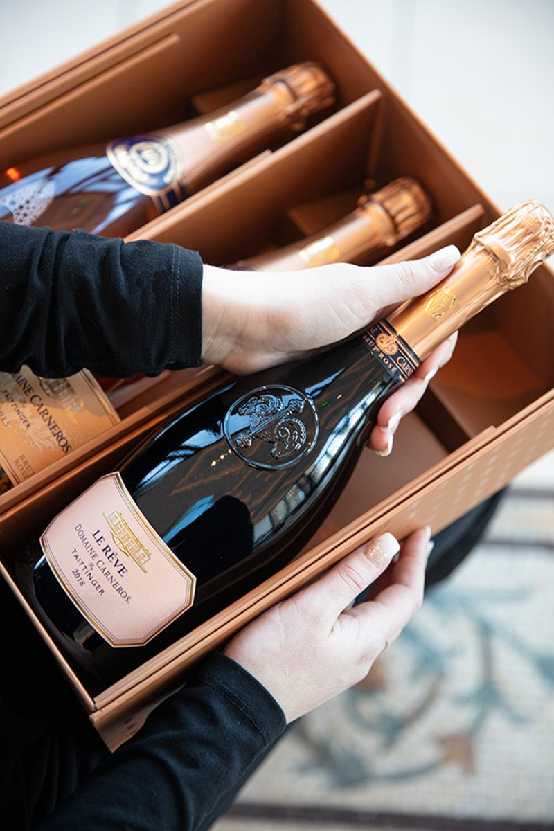 Bottle of Le Reve Rose being held with gift box